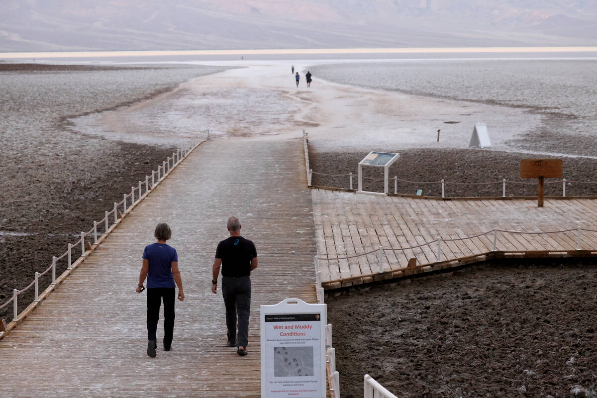Visitors check out a rare lake in Badwater Basin in Death Valley National Park in California on ...