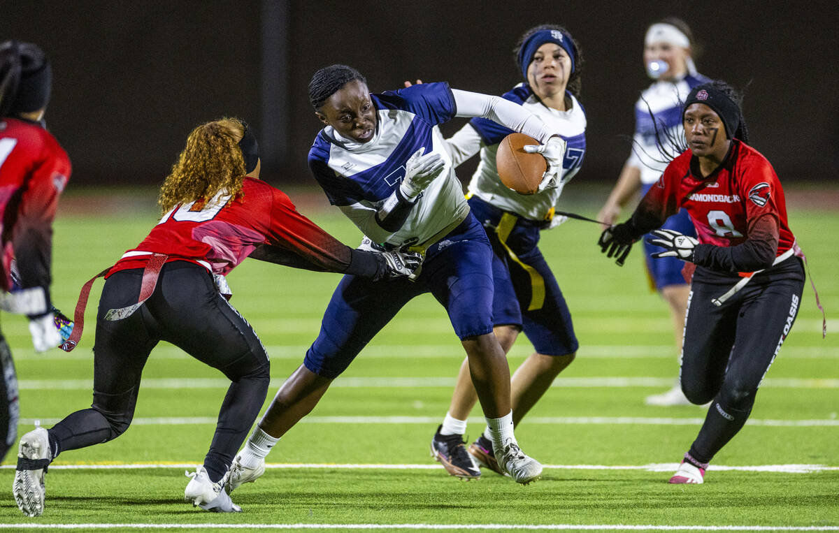 Shadow Ridge running back Kyla Moore (3) attempts to get past Desert Oasis defender Brooklin Hi ...