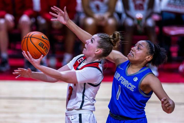 UNLV Lady Rebels guard Ashley Scoggin (0) gets inside of Air Force Falcons guard Alexis Cortez ...