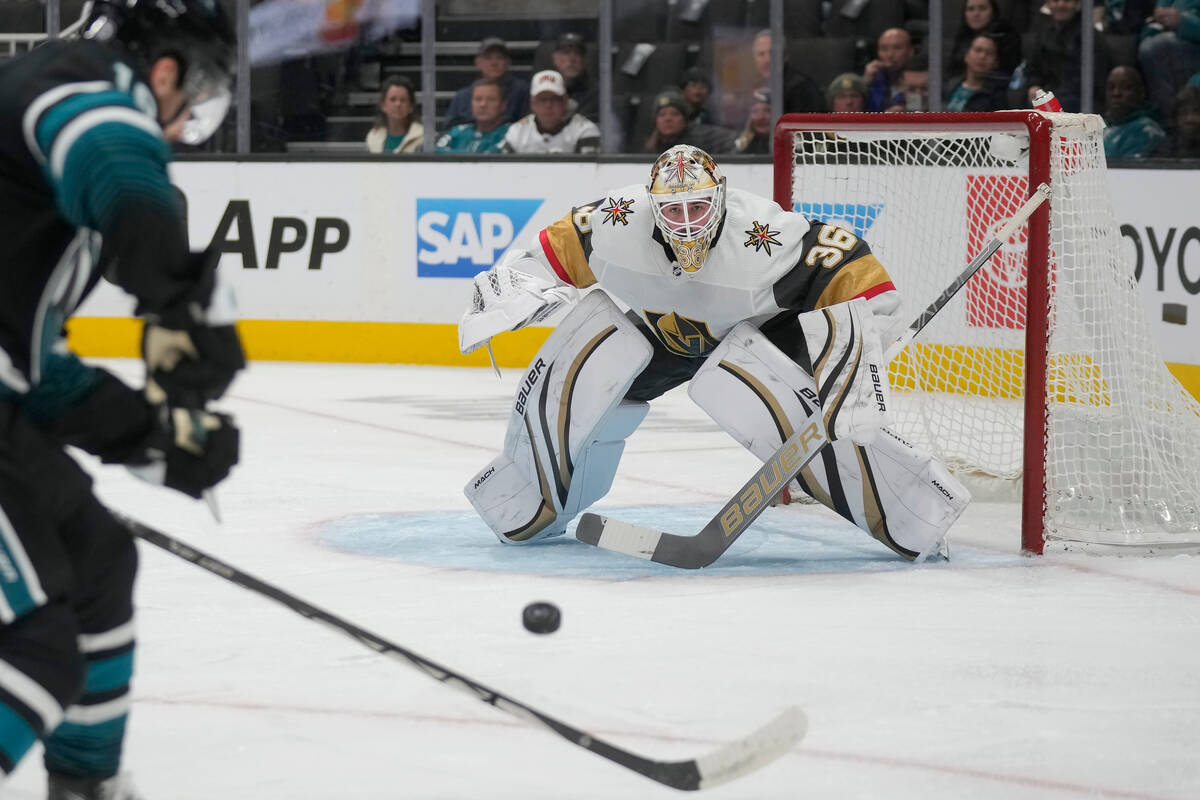 Vegas Golden Knights goaltender Logan Thompson (36) watches the puck as San Jose Sharks right w ...