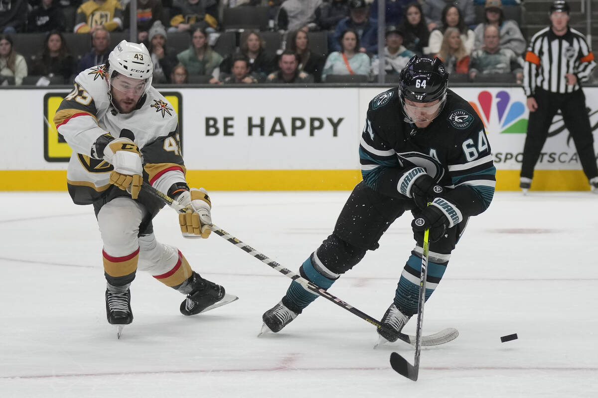 Vegas Golden Knights center Paul Cotter (43) reaches for the puck next to San Jose Sharks cente ...