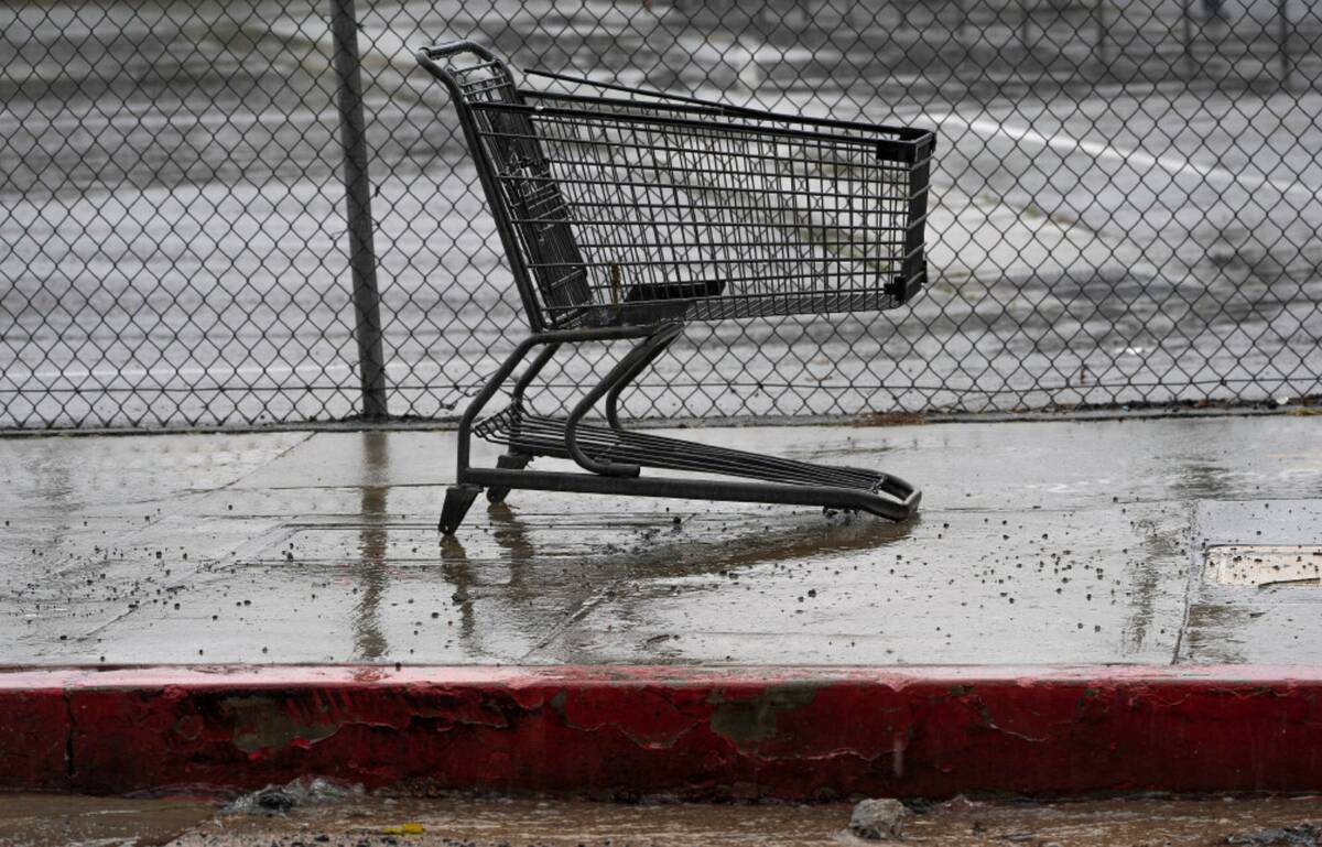 A shopping cart without wheels sits in the heavy rain in Los Angeles, Monday, Feb. 19, 2024. (A ...