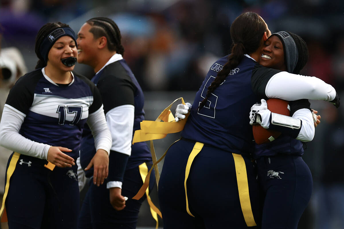 Shadow Ridge's Savanna McDow, right, and Abby Covington (5) embrace after McDow’s touchd ...