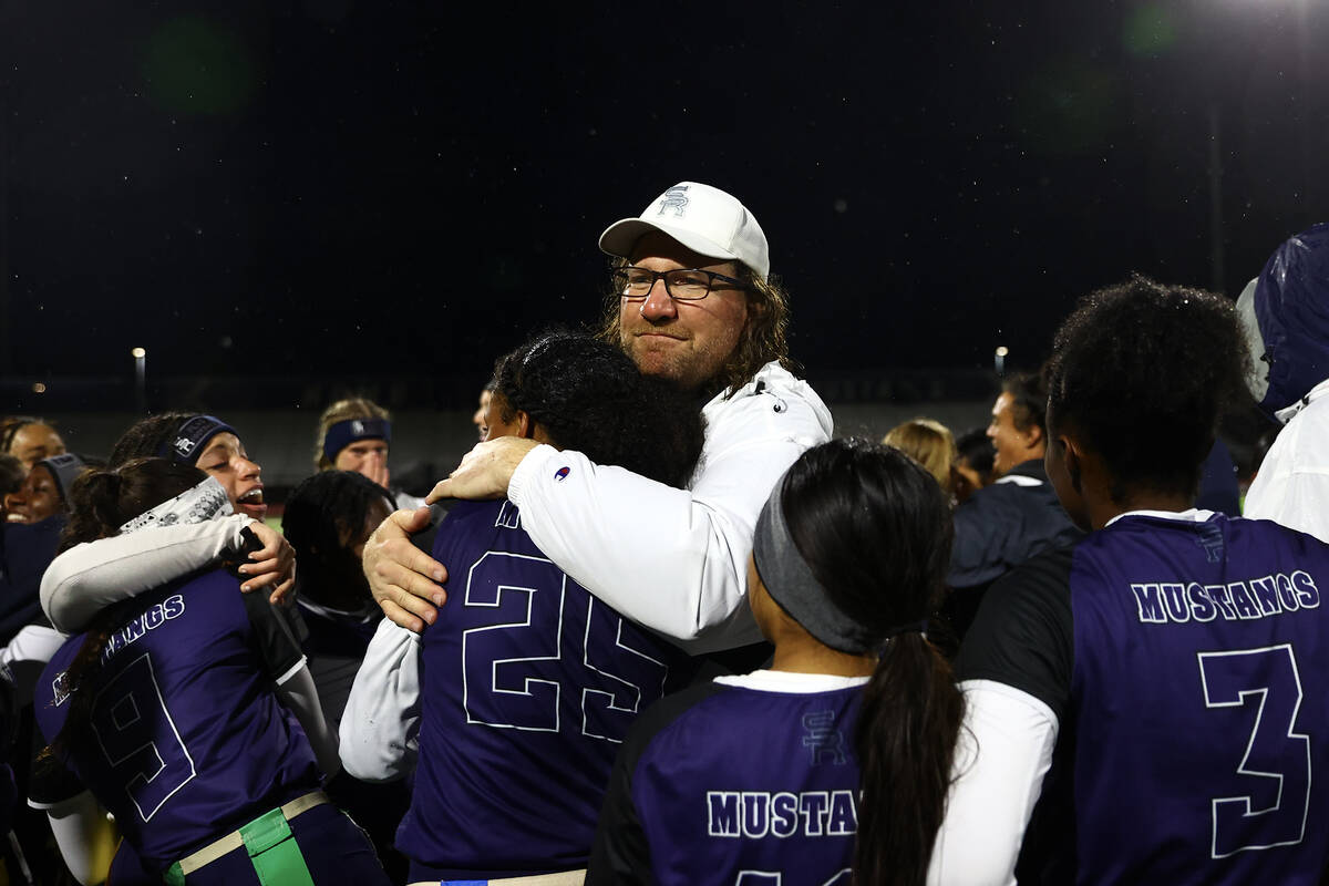 Shadow Ridge head coach Matthew Nighswonger hugs Jyniah Sanders (25) after they won the Class 5 ...