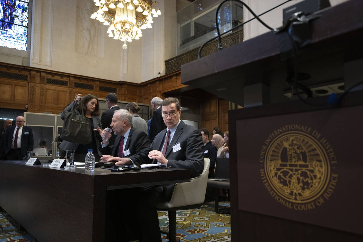 Richard C. Visek, acting legal adviser of the U.S. Department of state, center, waits to addres ...