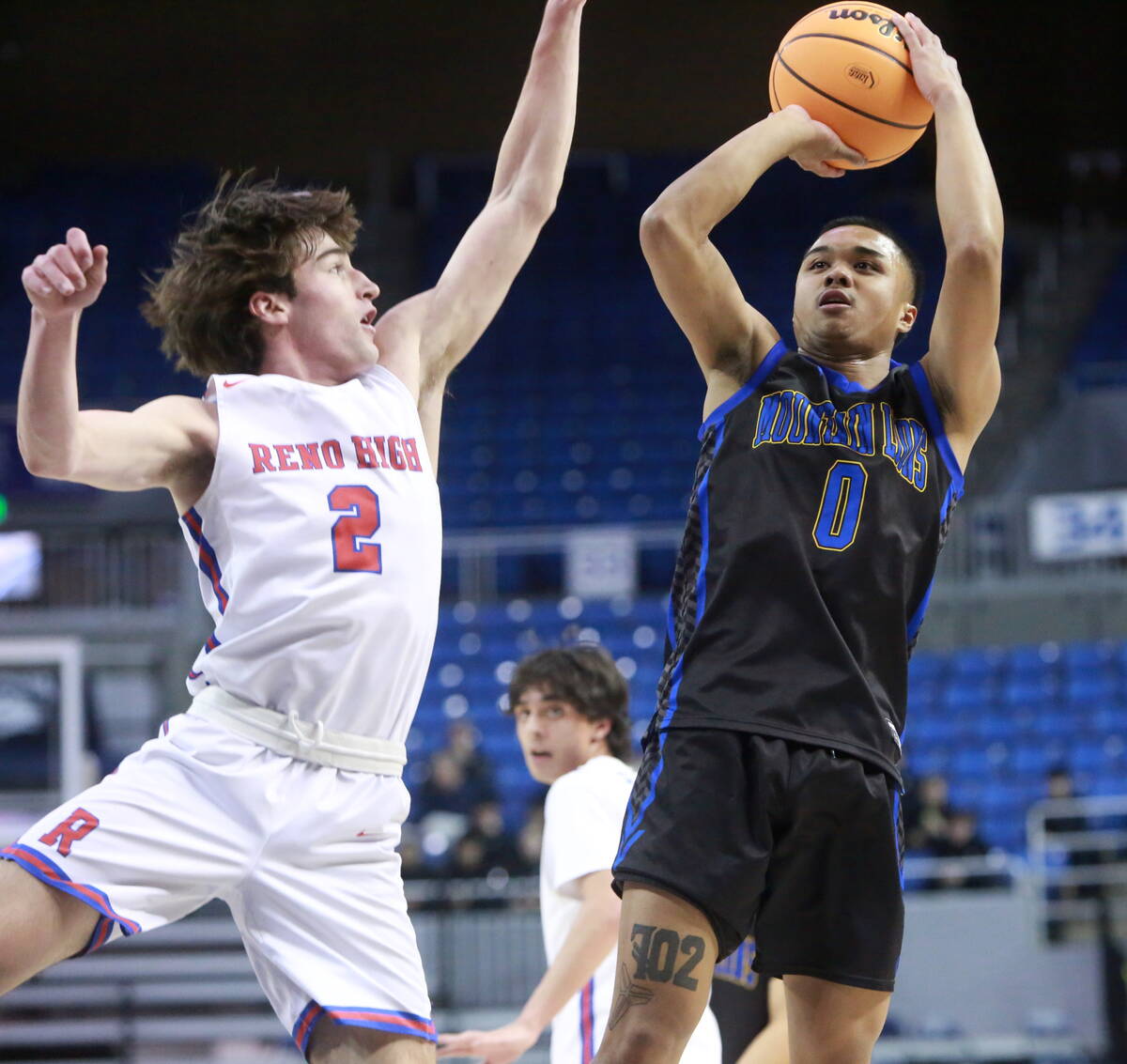 Sierra Vista junior guard EJ Dacuma, right, fades away while shooting a jumper against Reno sen ...