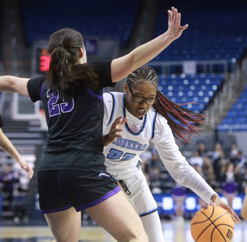 Canyon Springs senior center Kenijae Cherry, right, drives the lane against Spanish Springs sen ...