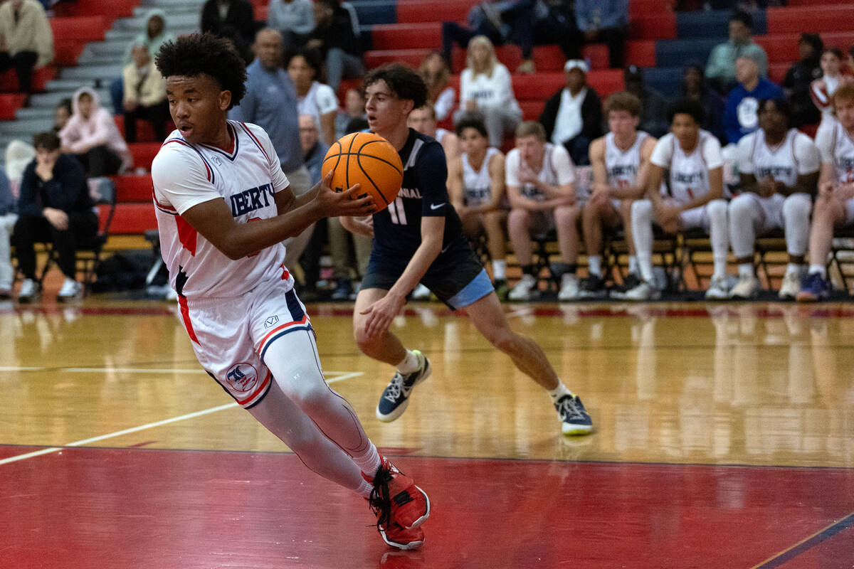 Liberty guard Tyus Thomas (0) pivots with the ball during the first half of a boys high school ...