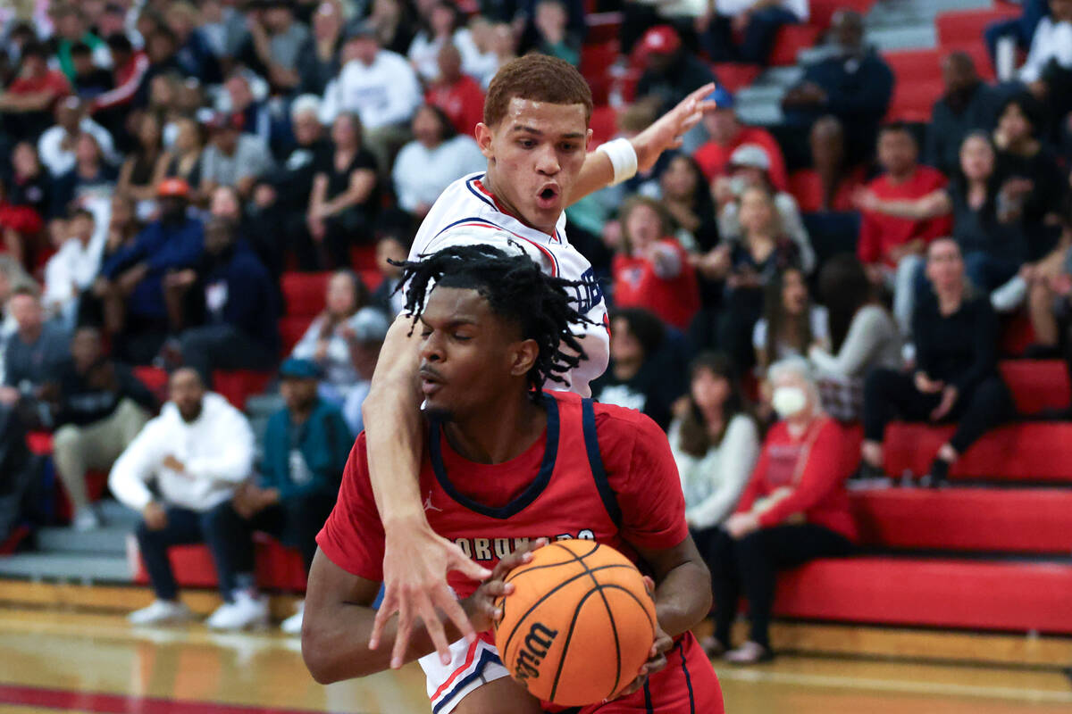 Liberty forward Dante Steward (15) fouls Coronado guard Josiah Cunningham (23) while he drives ...