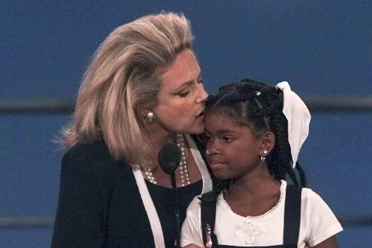 FILE - AIDS activist Mary Fisher kisses 12-year-old Hydeia Broadbent, a youngster who also has ...