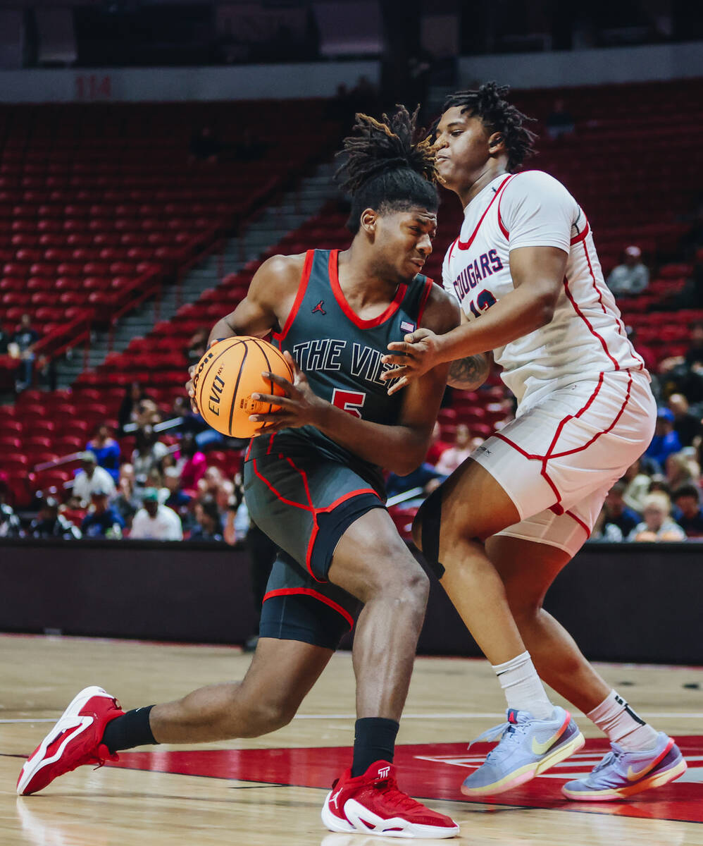 Arbor View’s Pharaoh Compton (5) drives his way to the basket during a Class 5A boys basketba ...