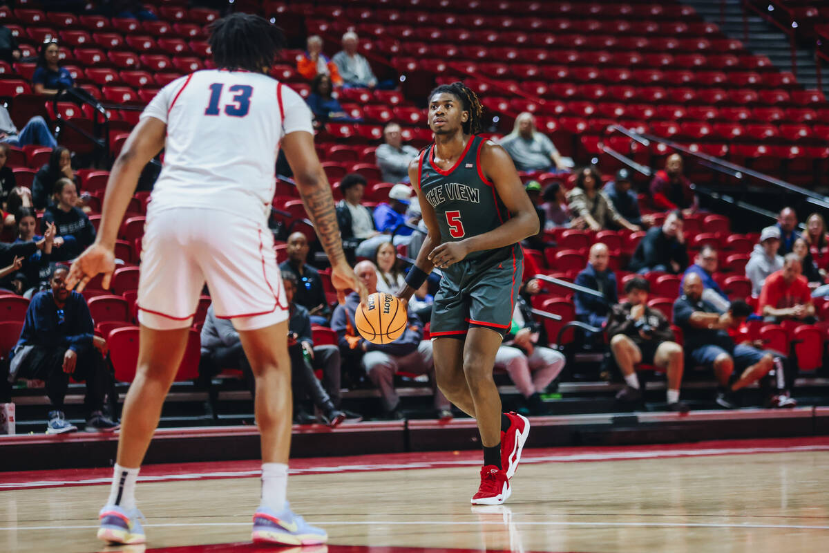 Arbor View’s Pharaoh Compton (5) dribbles the ball during a Class 5A boys basketball state se ...