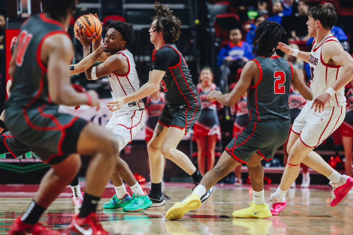 Coronado guard Jonny Collins (0) looks to move the ball as arbor View defenders close in on hi ...