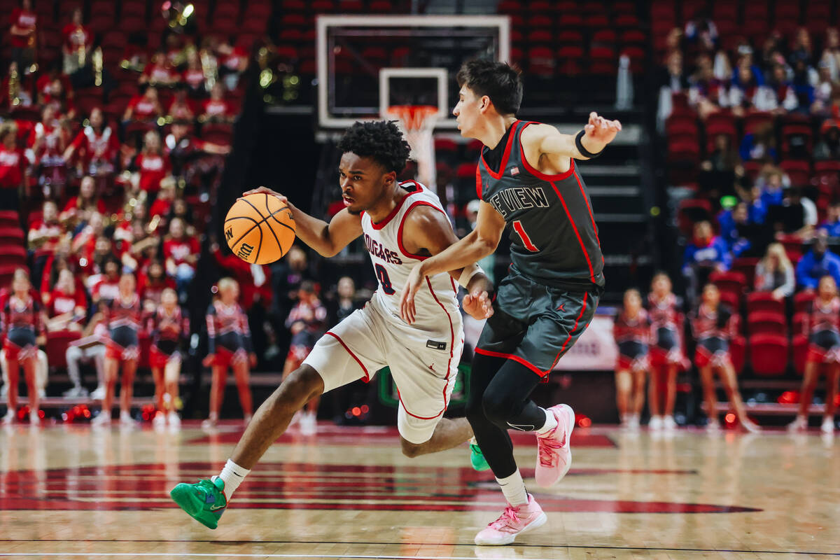 Coronado guard Jonny Collins (0) drives the ball during a Class 5A boys basketball state semifi ...