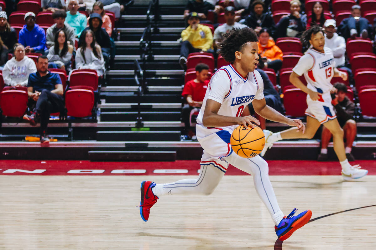 Liberty point guard Tyus Thomas (0) dribbles the ball down the court during a Class 5A boys bas ...