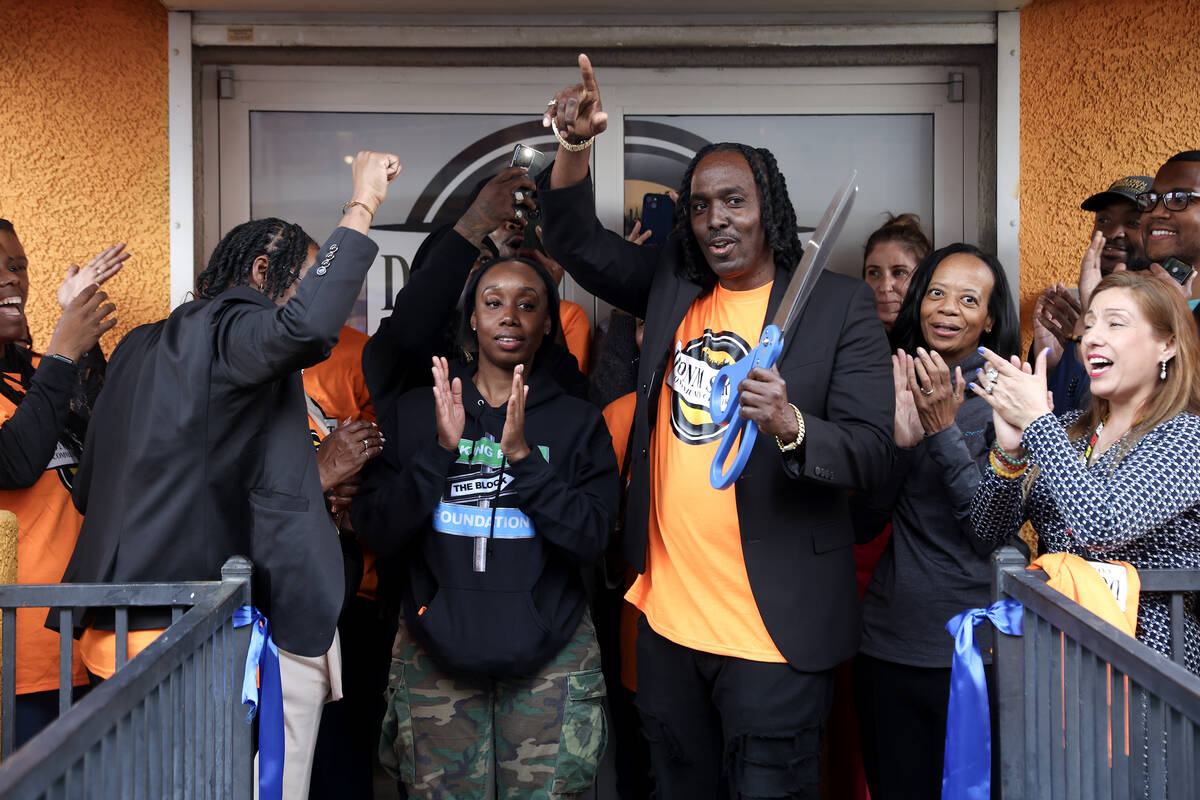 Founder Robert Strawder, center right, cheers after cutting a ribbon during an opening event at ...