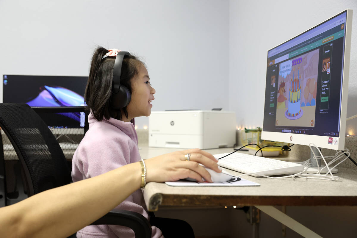 Gaby Santos, 4, enjoys the new computer facilities donated by Cox Communications during an open ...