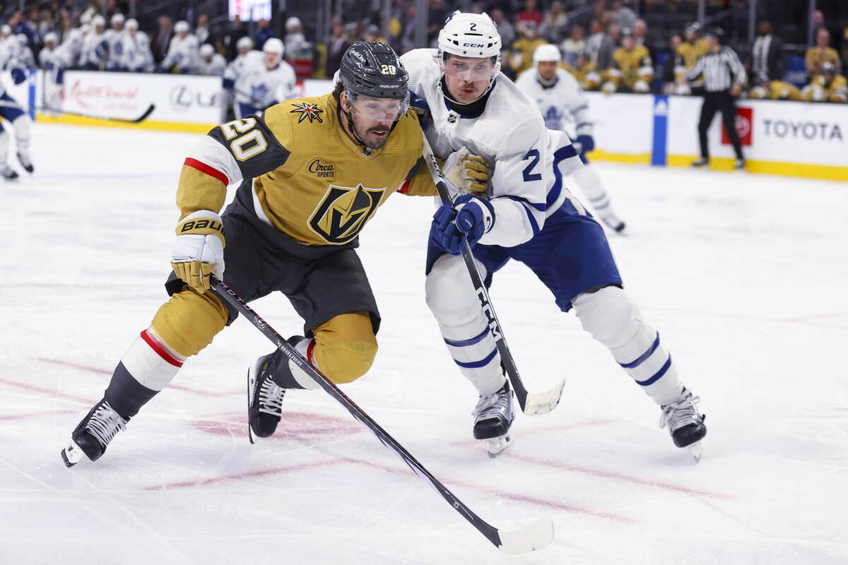 Vegas Golden Knights center Chandler Stephenson (20) collides with Toronto Maple Leafs defensem ...