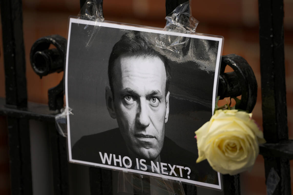 FILE - A flower and a picture are left as a tribute to Russian politician Alexei Navalny, near ...
