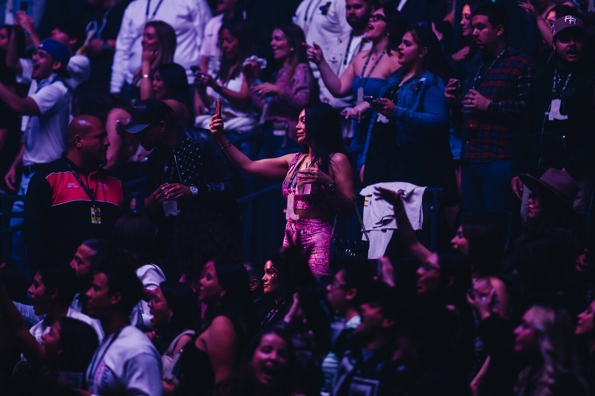 Bad Bunny fans watch as the singer performs during his Most Wanted Tour at T-Mobile Arena on Fr ...