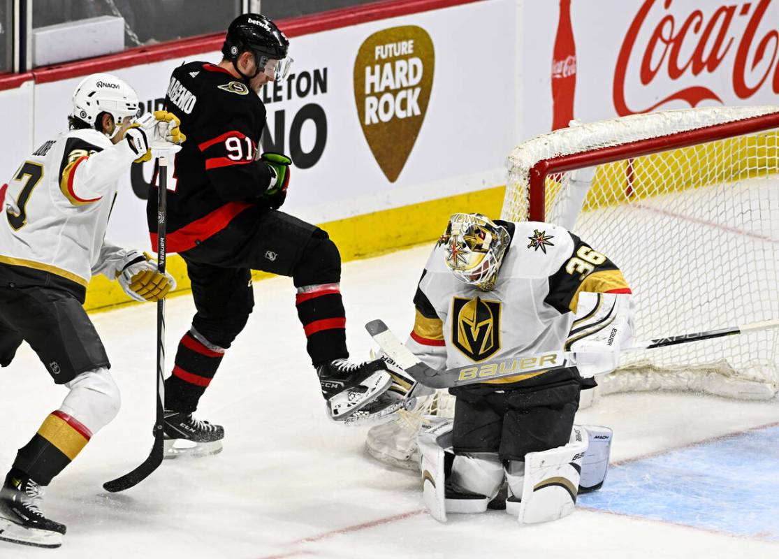 Vegas Golden Knights goaltender Logan Thompson (36) keeps the puck between his knees after maki ...