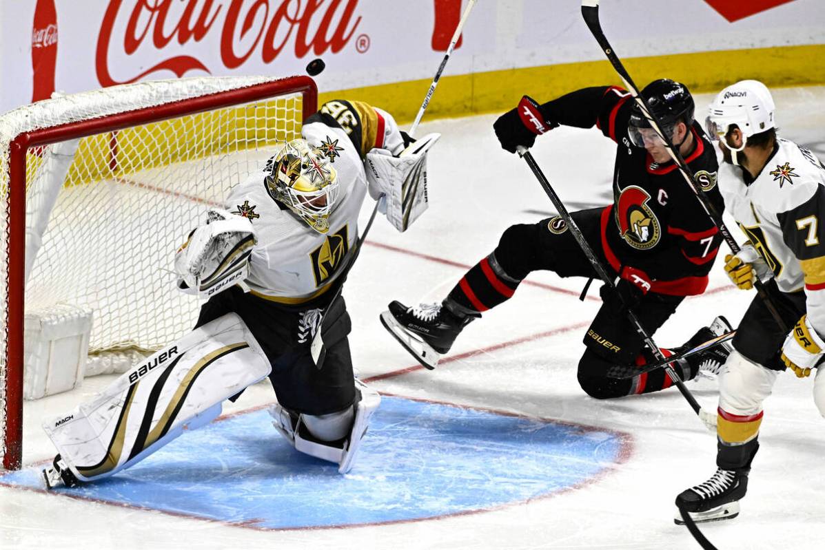 The puck bounces past the elbow of Vegas Golden Knights goaltender Logan Thompson (36) as Ottaw ...