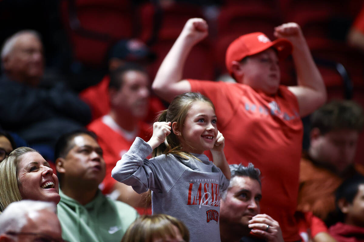 Young UNLV Rebels fans show their strength for the big screen during the first half of an NCAA ...