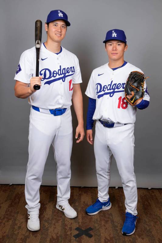 Los Angeles Dodgers designated hitter Shohei Ohtani, left, and starting pitcher Yoshinobu Yamam ...