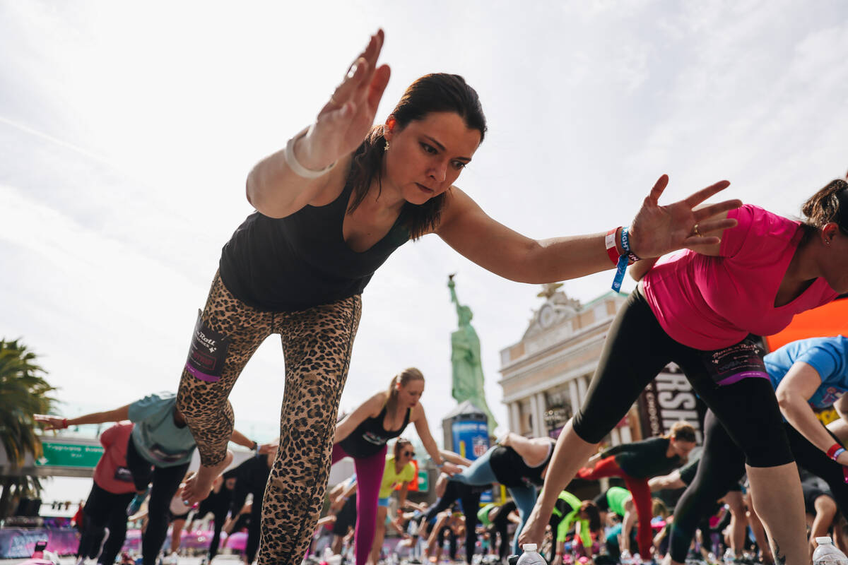 People gather on the Strip to do yoga while it is shut down for the Rock ’n’ Roll ...