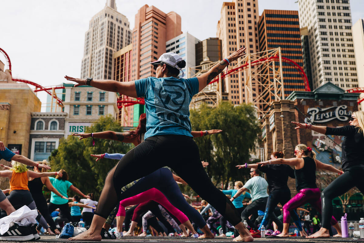 People gather on the Strip to do yoga while it is shut down for the Rock ’n’ Roll ...