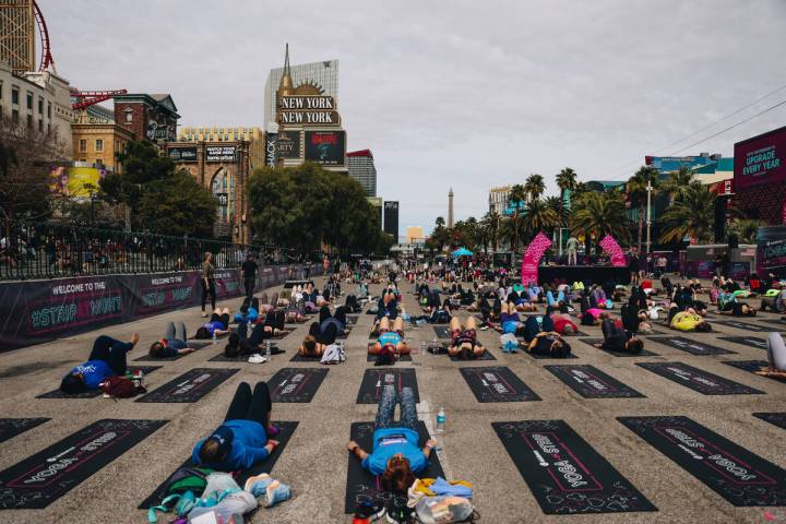 People gather on the Strip to do yoga while it is shut down for the Rock ’n’ Roll ...