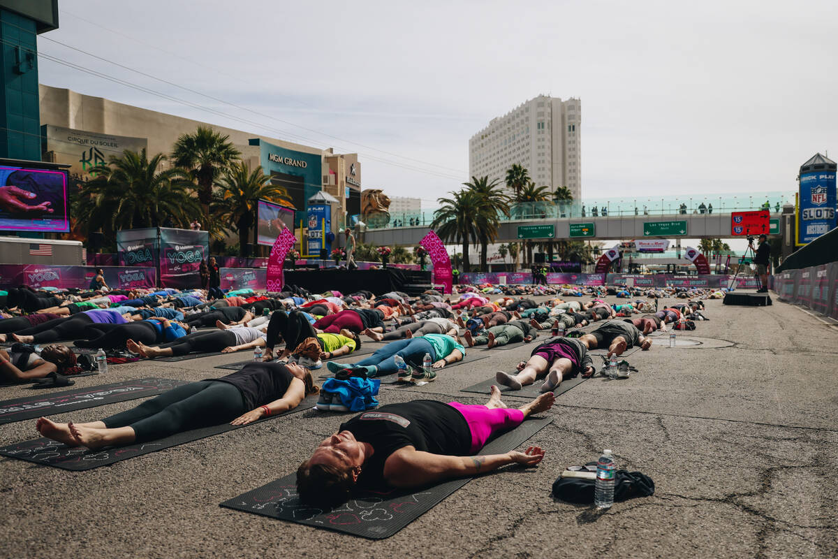 People gather on the Strip to do yoga while it is shut down for the Rock ’n’ Roll ...