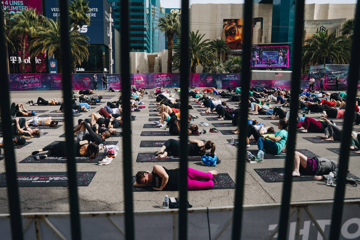 People gather on the Strip to do yoga while it is shut down for the Rock ’n’ Roll ...