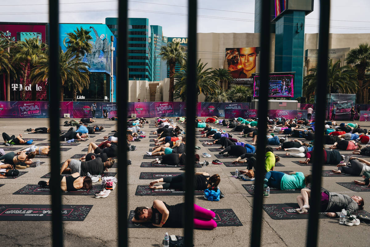 People gather on the Strip to do yoga while it is shut down for the Rock ’n’ Roll ...