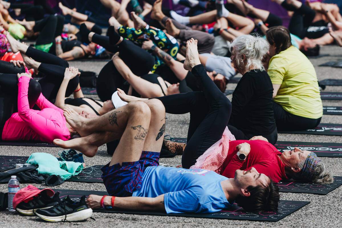 People gather on the Strip to do yoga while it is shut down for the Rock ’n’ Roll ...