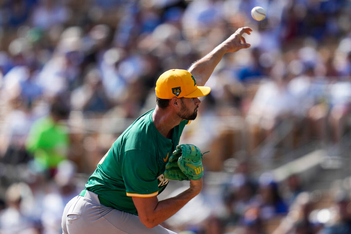 Oakland Athletics starting pitcher Kyle Muller throws during the first inning of a spring train ...