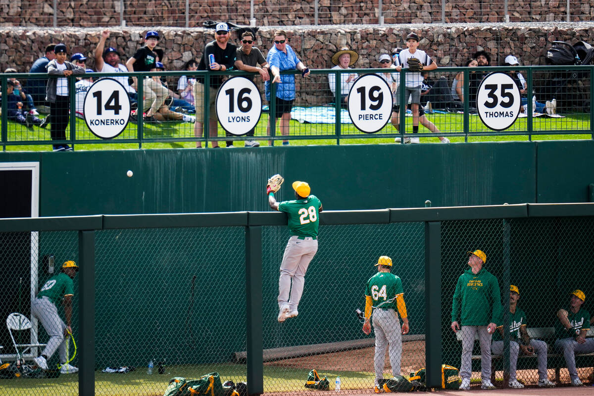 Oakland Athletics right fielder Daz Cameron (28) reaches for a home run ball hit by Los Angeles ...