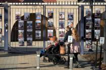 A family walks up to the entrance of the Israeli Embassy, Monday, Feb. 26, 2024, in Washington. ...