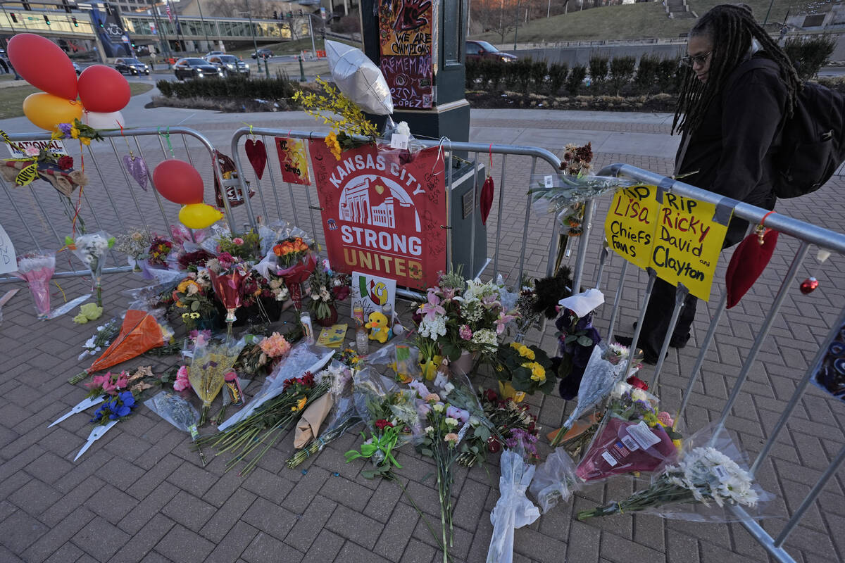 A person views a memorial dedicated to the victims of last week's mass shooting in front of Uni ...