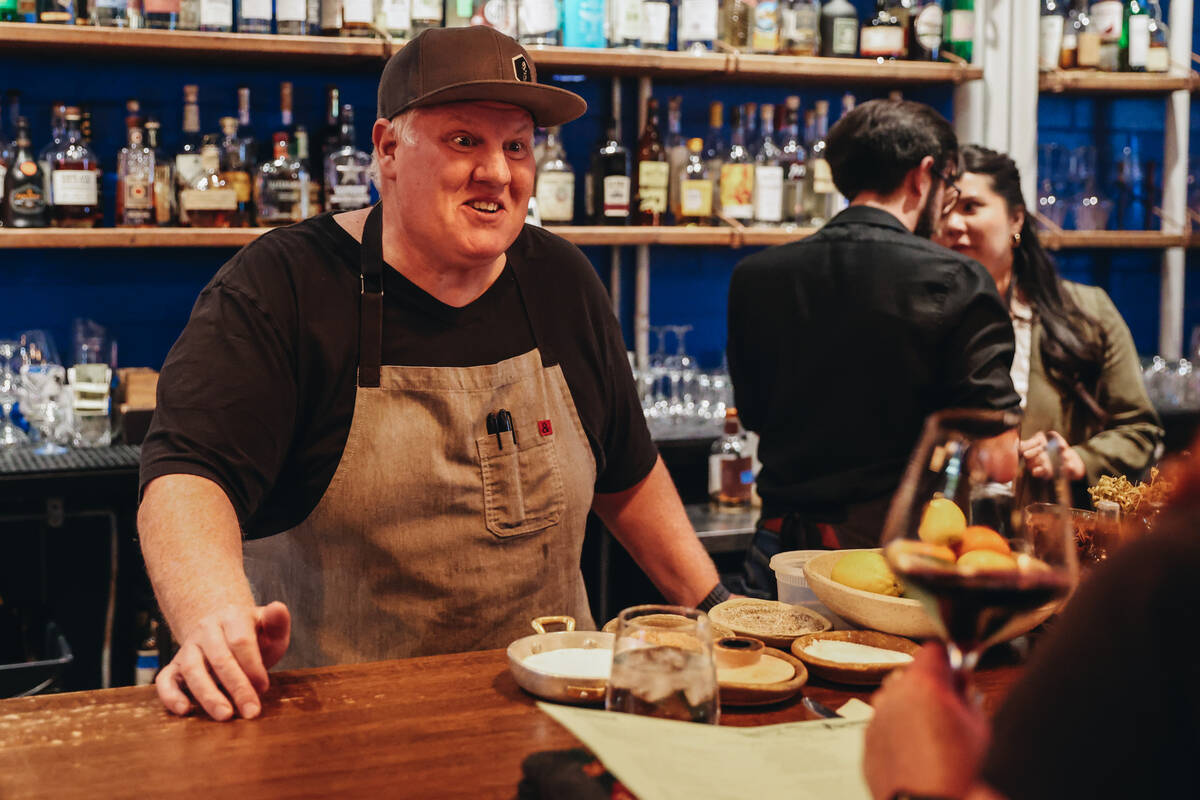 Esther’s Kitchen chef and owner James Trees speaks to people at the bar at Esther&#x2019 ...