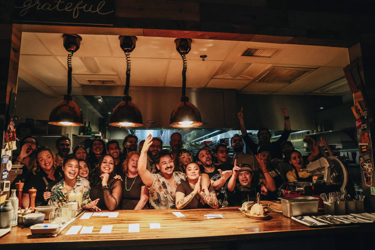 The staff at Esther’s Kitchen pose for photographs on the last night of service before moving ...