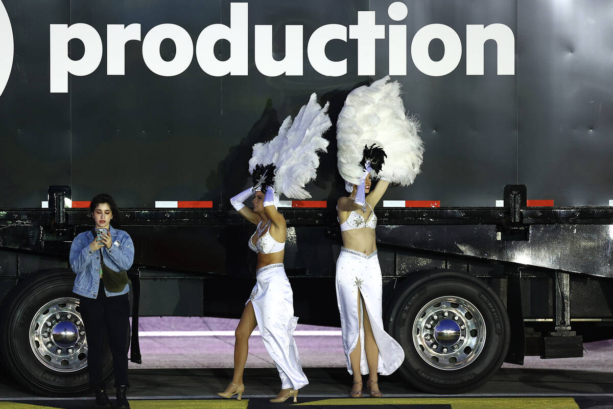 Showgirls struggle to keep their headdresses on amid high wind conditions during the Victoria's ...