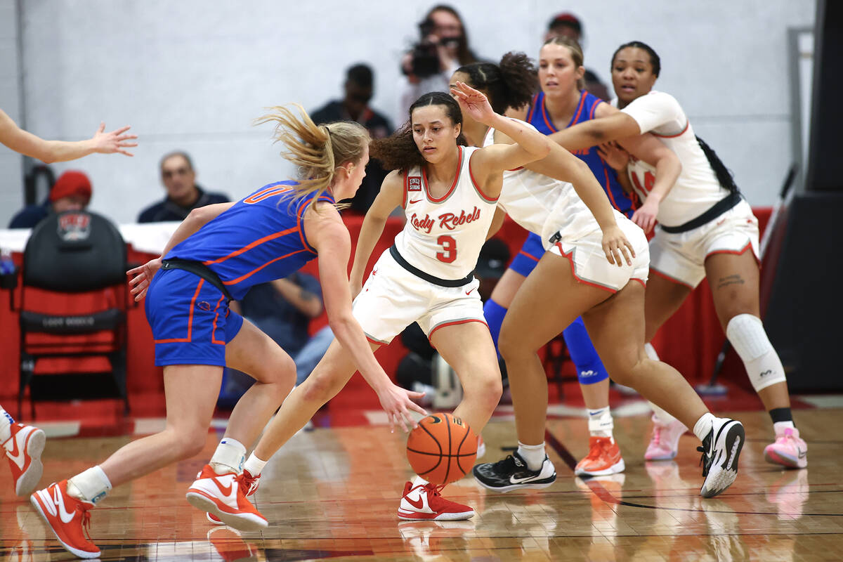 UNLV Lady Rebels guard Kiara Jackson (3) defends against Boise State Broncos guard Tatum Thomps ...