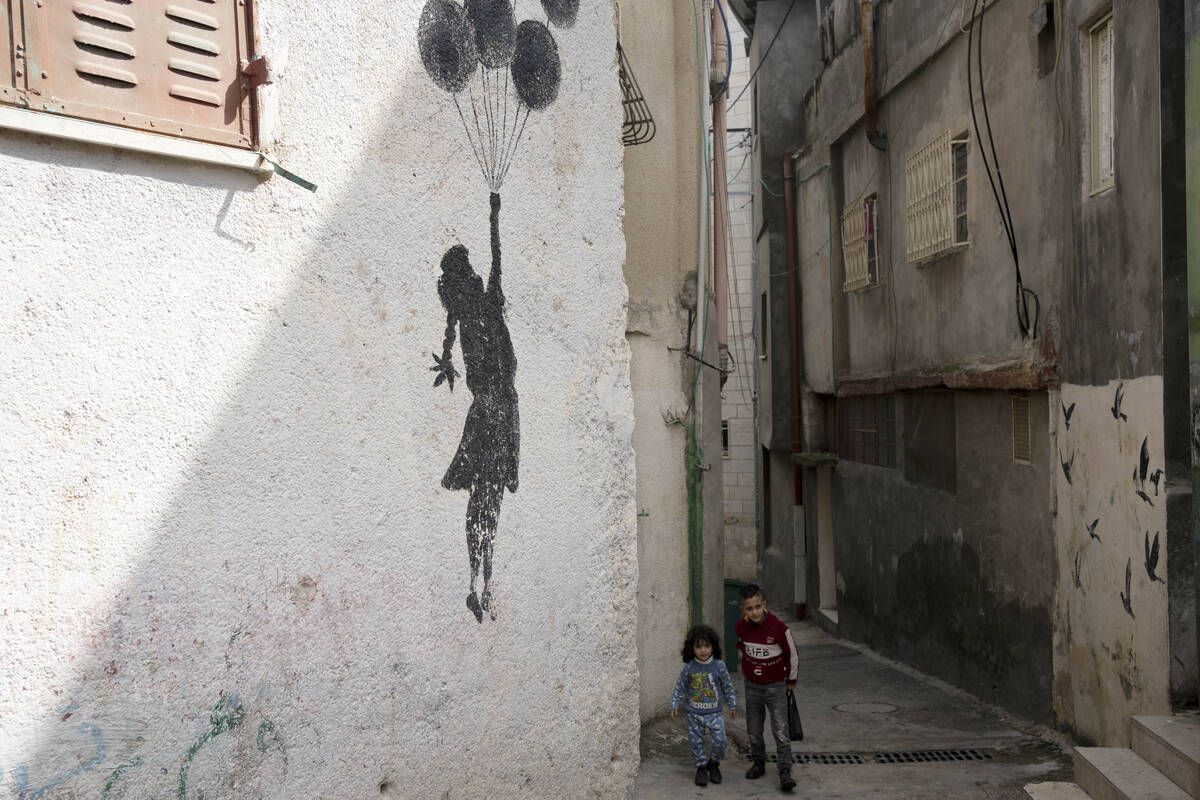 Palestinian children walk in an alley of the Aida Refugee Camp, near the health clinic and scho ...