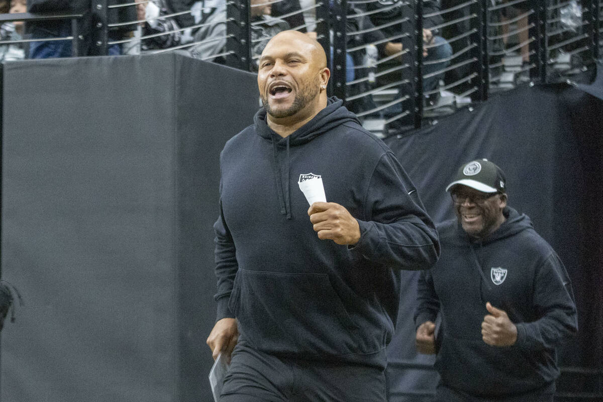 Raiders interim head coach Antonio Pierce takes the field before an NFL game against the Denver ...