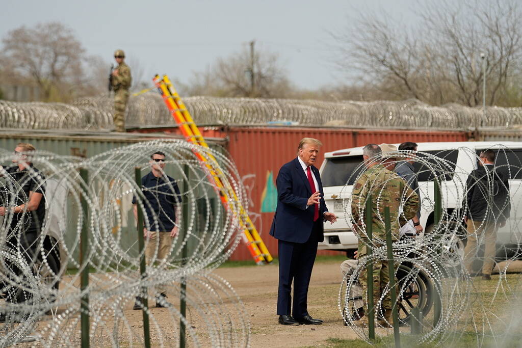 Republican presidential candidate former President Donald Trump talks with Maj. Gen. Thomas Sue ...