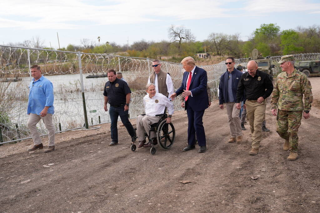 Republican presidential candidate former President Donald Trump talks with Texas Gov. Greg Abbo ...