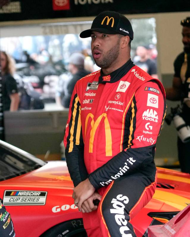 Bubba Wallace stands in his garage before a practice session for the NASCAR Daytona 500 auto ra ...