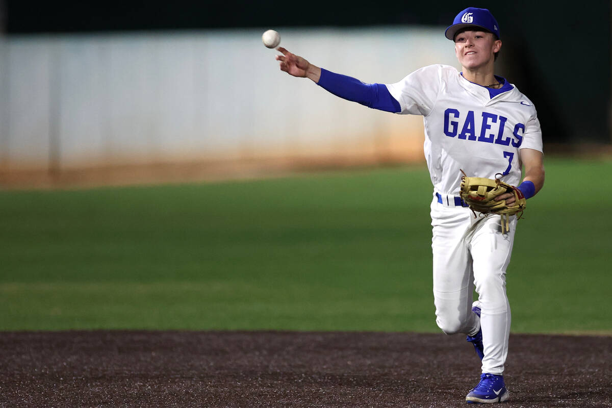 Bishop Gorman short stop Colton Boardman throws to first base during a high school baseball gam ...