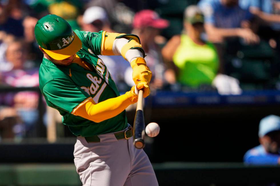 Oakland Athletics' Brent Rooker hits a single against the Kansas City Royals during the first i ...